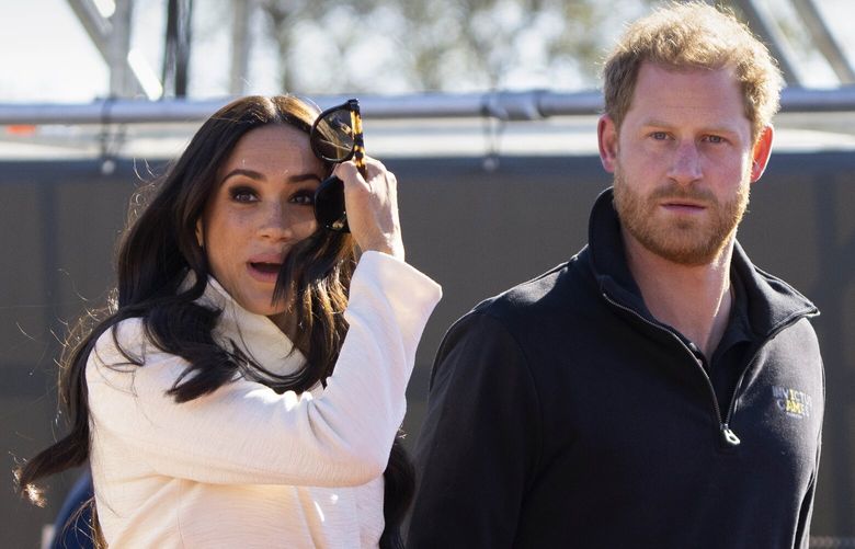FILE – Prince Harry and Meghan Markle, Duke and Duchess of Sussex visit the track and field event at the Invictus Games in The Hague, Netherlands, Sunday, April 17, 2022.  A spokesperson for Prince Harry and his wife Meghan says the couple were involved in a car chase while being followed by photographers. The couple’s office says the pair and Meghan’s mother were followed for more than two hours by a half-dozen vehicles after leaving a charity event in New York on Tuesday, May 16, 2023. (AP Photo/Peter Dejong, File) NY135 NY135