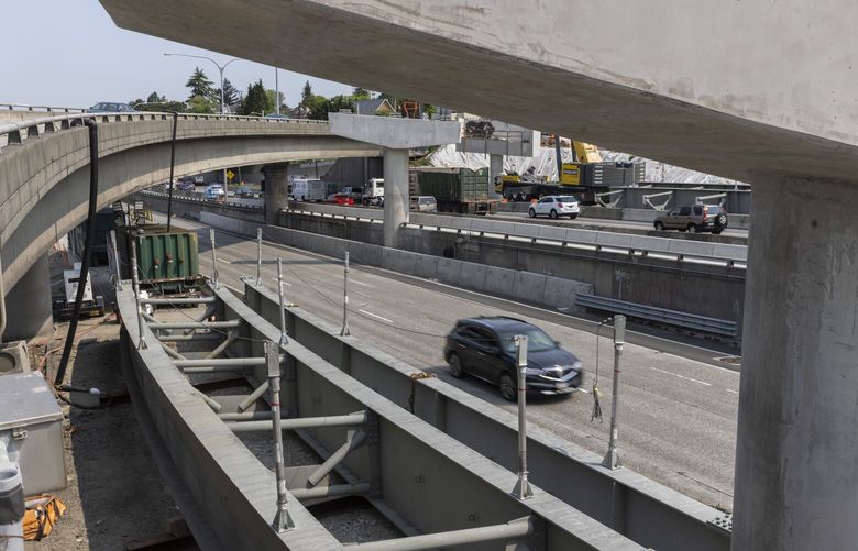 Girders in the foreground will be raised up over I-5 near Hwy. 520  this coming weekend.  Northbound lanes on I-5 (at top right) will be closed from Friday at 10 p.m. until Saturday at 10 a.m. and the express lanes (at center) will be closed from 11 a.m. Saturday until 10 a.m. Sunday.  The current exit from Hwy. 520, which is currently one lane (at top left), will be replaced with a new one with three lanes.   

There will be slowdowns ahead for drivers as I-5 and I-405 construction ramp up this week 223872