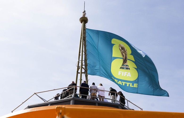 The new Seattle FIFA World Cup logo flows on top of the Space Needle in Seattle on Thursday, May 18, 2023.