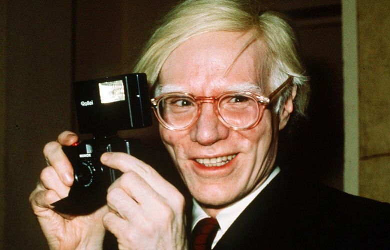 FILE – In this 1976 file photo, pop artist Andy Warhol smiles in New York. The Supreme Court on Thursday, May 18, 2023, sided with a photographer who claimed the late Andy Warhol had violated her copyright on a photograph of the singer Prince. The Supreme Court sided 7-2 with photographer Lynn Goldsmith. The case involved images Warhol created of Prince as part of a 1984 commission for Vanity Fair. Warhol used a Goldsmith photograph as his starting point. (AP Photo/Richard Drew, File) WX102 WX102