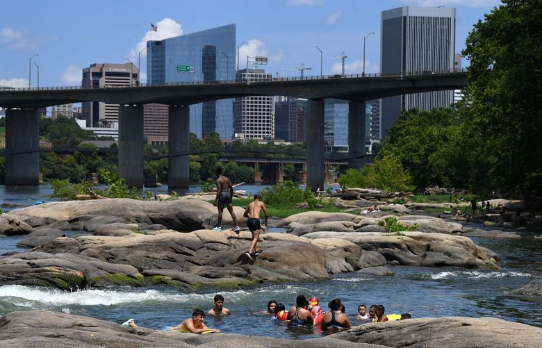 People cool off in the James River at Belle Isle on Sunday July 19, 2020 in Richmond, Va.