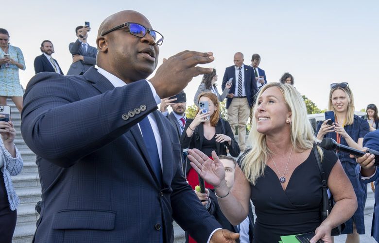 Rep. Jamaal Bowman, D-N.Y., left, and Rep. Marjorie Taylor Greene, R-Ga., argue on the steps of the Capitol after Bowman shouted down Rep. George Santos, R-N.Y., who was speaking to reporters following an effort to expel him from the House, in Washington, Wednesday, May 17, 2023. Santos has been charged with embezzling money from his campaign, falsely receiving unemployment funds and lying to Congress about his finances. He has denied the charges and has pleaded not guilty. (AP Photo/J. Scott Applewhite) DCSA124 DCSA124