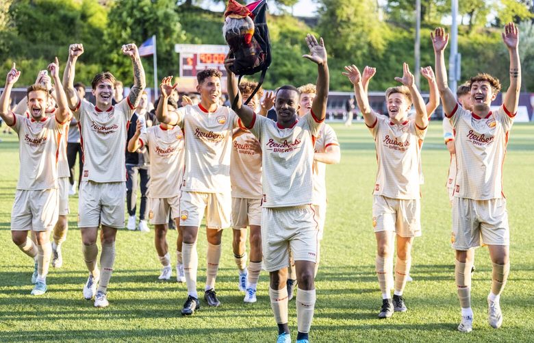 Ballard FC celebrates after winning their first game against  Lane United FC at Interbay Stadium on May 21, 2022.
