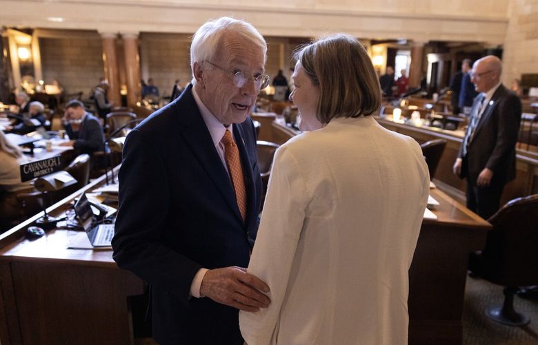 Nebraska state Sen. Merv Riepe chats with fellow Sen. Jane Raybould on the floor of the legislature at the Nebraska Capitol in Lincoln, Neb., on May 4. Sen. Riepe, a longtime Republican, would have been the decisive vote to advance a “heartbeat” abortion bill to a final round of voting but he abstained over his concern that it might not give women enough time to know they are pregnant. MUST CREDIT: Photo for The Washington Post by Rebecca S. Gratz
