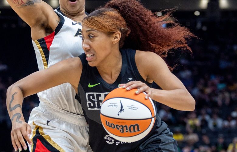 Seattle Storm’s Arella Guirantes drives with Las Vegas’ Aces Kierstan Bell defended Saturday afternoon at the Climate Pledge Arena in Seattle, Washington on May 20, 2023. The Storm lost 105-64 in the season opener against the Aces.