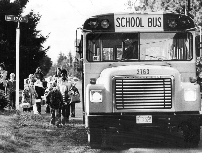Students wait for a bus in the fall of 1978, when Seattle began districtwide busing to desegregate schools.   (Kathy Andrisevic / The Seattle Times, 1978)