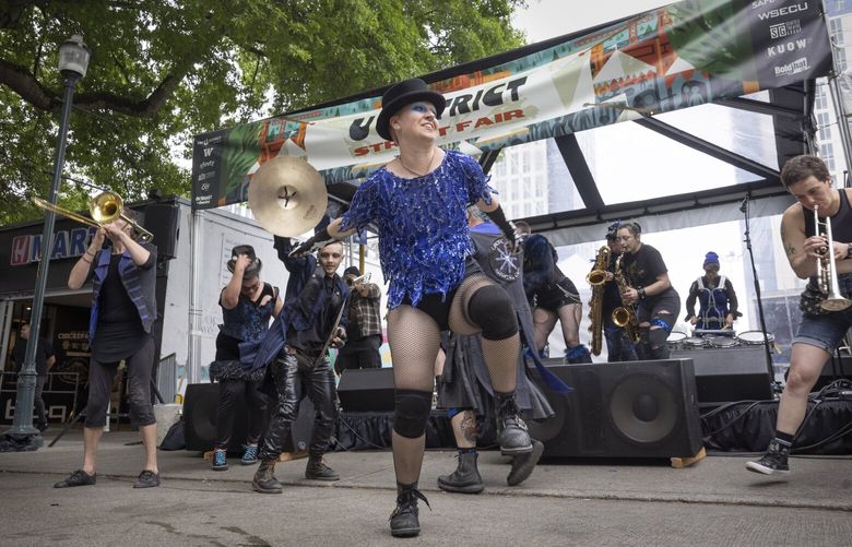 Dragon Migwyn with Chaotic Noise Marching Corps, dances for the crowd at the 52nd U District Fair Sunday, May 21, 2023.
The U District Street Fair returns for its 52nd year during the weekend of May 20-21, 2023 kicking-off Seattle’s summer event season with a 10 block-long arts and crafts fair that takes over University Way (a.k.a. “The Ave”). The two-day event will also feature free live music and performances, and over 40 food trucks and booths. This Seattle tradition regularly attracts over 50,000 visitors. 223981