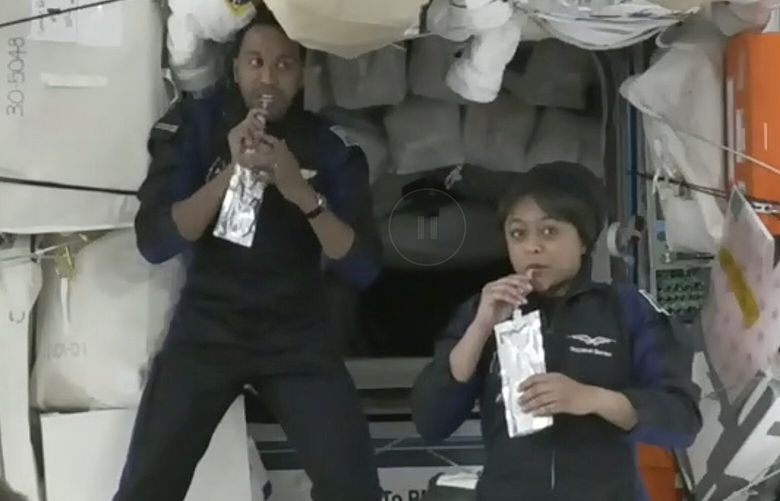In this image from NASA TV, Ali al-Qarni, second from left, and Rayyanah Barnawi of Saudi Arabia, second right, have a drink alongside two cosmonauts in the International Space Station, Monday, May 22, 2023. The space station rolled out the welcome mat for the two Saudi visitors, including the kingdom’s first female astronaut. (NASA TV via AP) NYPS314 NYPS314