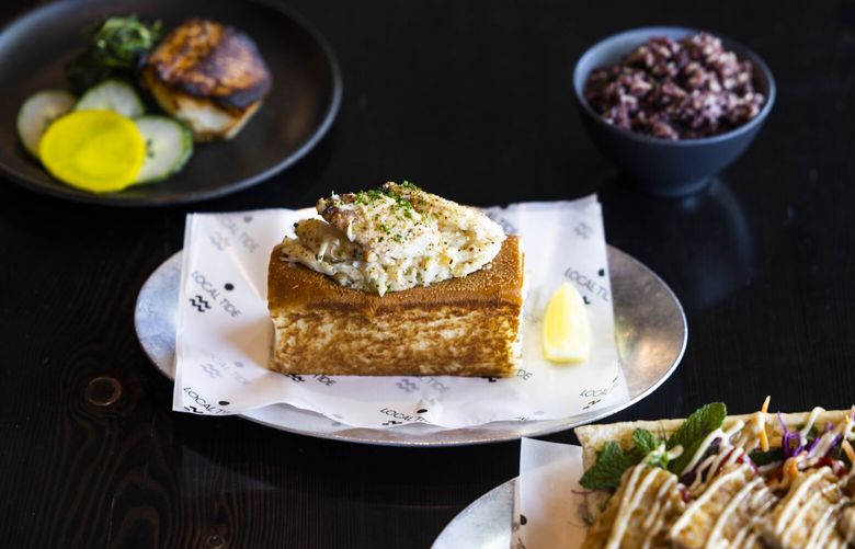 From left the black cod kazuzuke with rice, crab roll and rockfish banh mi at Local Tide in Fremont in Seattle on Friday, May 19, 2023.