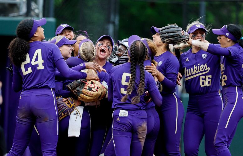 The Husky softball team celebrates their 7-6 win over McNeese State. 223995