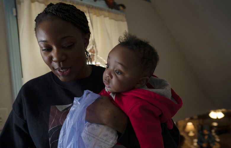 Ansonia Lyons carries her son, Adrien Lyons, as she takes him for a diaper change in Birmingham, Ala., on Saturday, Feb. 5, 2022. Black babies are more likely to die, and also far more likely to be born prematurely, like Adrien, setting the stage for health issues that could follow them through their lives. (AP Photo/Wong Maye-E) NYWM509 NYWM509