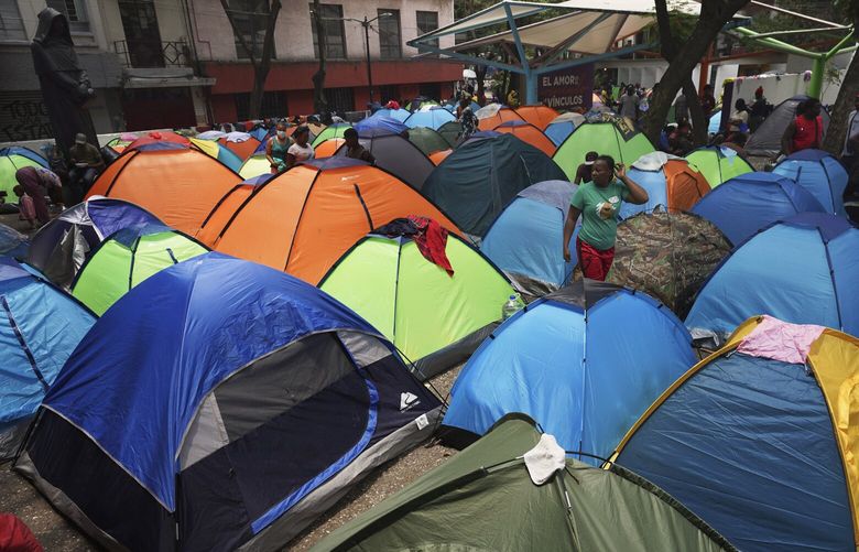 FILE – Haitian migrants camp out at the Giordano Bruno plaza in Mexico City, May 18, 2023. The group was staying at a shelter in Mexico City on their way north but were forced to make camp at the park after the shelter closed. (AP Photo/Marco Ugarte, File) XLAT120 XLAT120