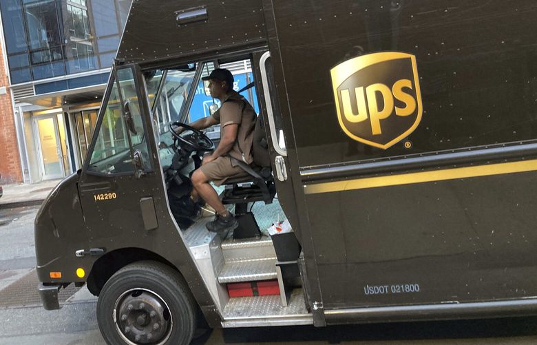 A United Parcel Service driver pilots his truck, in New York, Thursday, May 11, 2023. More than 340,000 unionized United Parcel Service employees, including drivers and warehouse workers, say they are prepared to strike if the company does not meet their demands before the end of the current contract on July 31.  (AP Photo/Richard Drew) NYPM205 NYPM205
