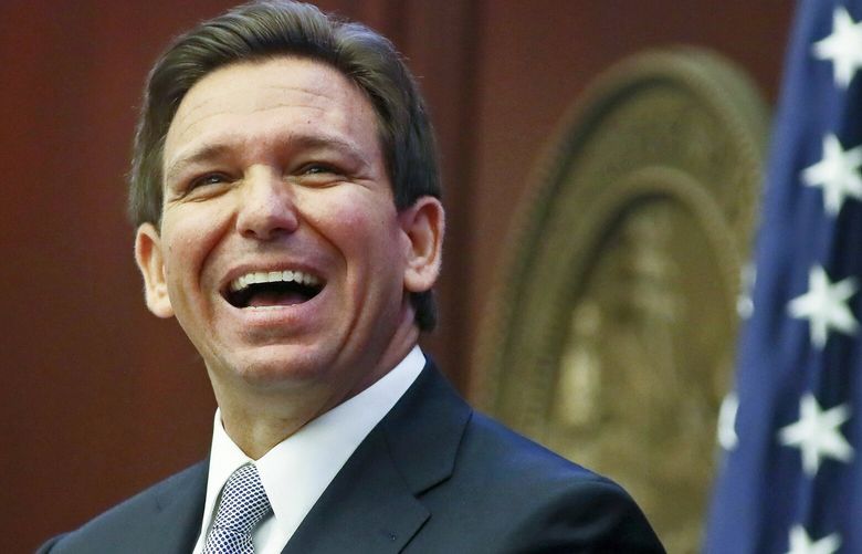 FILE – Florida Gov. Ron DeSantis reacts to applause as he gives his State of the State address during a joint session of the Senate and House of Representatives March 7, 2023, at the Capitol in Tallahassee, Fla. (AP Photo/Phil Sears, File) WX450 WX450