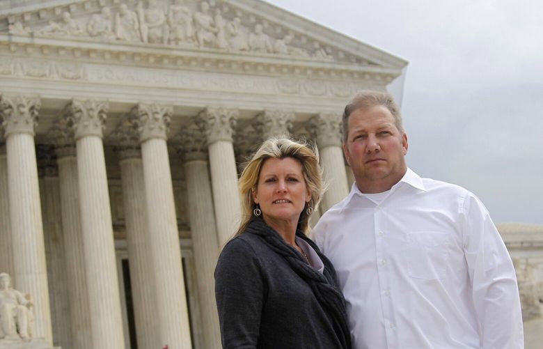 FILE – Michael and Chantell Sackett of Priest Lake, Idaho, pose for a photo in front of the Supreme Court in Washington on Oct. 14, 2011. The Supreme Court on Thursday, May 25, 2023, made it harder for the federal government to police water pollution in a decision that strips protections from wetlands that are isolated from larger bodies of water. The justices boosted property rights over concerns about clean water in a ruling in favor of an Idaho couple who sought to build a house near Priest Lake in the state’s panhandle. (AP Photo/Haraz N. Ghanbari, File) WX104 WX104