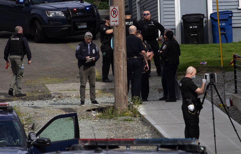 Seattle police officers gather near an alley where there was an officer-involved shooting, near 37th Ave South and South Dakota St in the Mt. Baker neighborhood Wednesday, April 29, 2029,
The shooting occurred following a domestic violence call involving a man with a firearm in a nearby park. He assaulted a woman several times during the day and then grabbed their child. The child is not injured. The woman was badly assaulted. The suspect was shot by police and is in custody. 213820