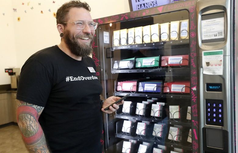 Christopher Archiopoli, Director of Peer Seattle, with a vending machine in their lobby that has a vending machine to distribute Narcan and fentanyl test strips. It’s provided by King County Public Health. The goal is to distribute these overdose prevention supplies, even to folks who might fear the stigma of having to ask for them.  223893