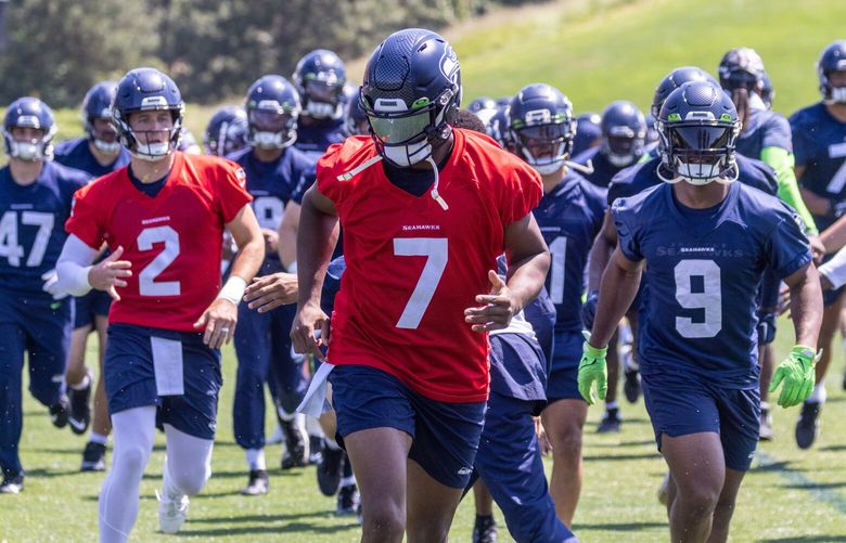 Seahawks quarterback Geno Smith (7) leads the rush to drills Thursday afternoon Virginia Mason Athletic Center in the Renton, Washington on May 25, 2023.