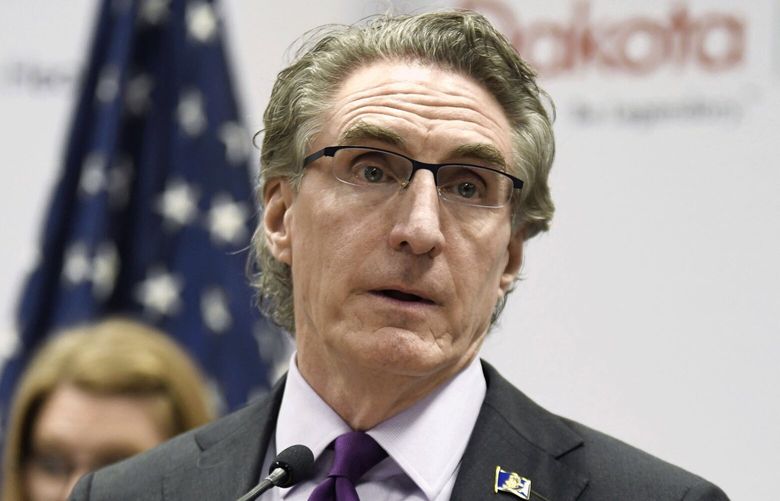 FILE – North Dakota Gov. Doug Burgum speaks at the state Capitol on April 10, 2020, in Bismarck, N.D. Burgum has signed a bill into law that allows public school teachers and state government employees to ignore the pronouns their transgender students and colleagues use, the governor’s office announced Monday, May 8, 2023 (Mike McCleary/The Bismarck Tribune via AP, File) NDBIS151 NDBIS151