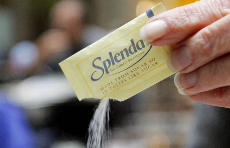 An unidentifed woman pours Splenda into a cup in a coffee shop in Boston Friday, Dec. 3, 2004. Dieters hoping for a slew of new products with the sugar substitute Splenda may be disappointed next year. That’s because the maker of sucralose, the key ingredient behind the increasingly ubiquitous no-calorie sweetener, is having trouble keeping up with demand. (AP Photo/Winslow Townson) BX108