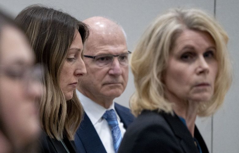 Dr. Caitlin Bernard, left, sits between attorneys John Hoover and Alice Morical on Thursday, May 25, 2023, before a hearing in front of the state medical board at the Indiana Government South building in downtown Indianapolis. Bernard is appearing before the board for the final hearing in a complaint filed by Attorney General Todd Rokita saying she violated patient privacy laws and reporting laws. (Mykal McEldowney/The Indianapolis Star via AP) ININS202 ININS202