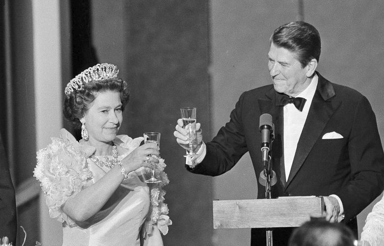 FILE – President Ronald Reagan and Queen Elizabeth II raise their glasses in a toast during a state dinner, March 3, 1983, at the M. H. de Young Museum in San Francisco’s Golden Gate Park. Woman at right is unidentified. The FBI has disclosed a potential threat to the late Queen Elizabeth during her 1983 trip to the U.S. West Coast. The documents were released this last week of May, 2023, on the FBI’s records website. (AP Photo/Ed Reinke, File) NYWS301 NYWS301