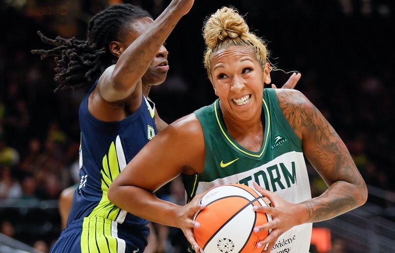 Seattle Storm center Mercedes Russell grimaces as she spins around Dallas Wings forward Natasha Howard during the first quarter. 224038