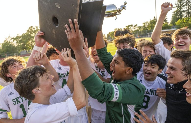 Skyline players celebrate as they hoist the state championship trophy after beating Puyallup, 2-0, in the Class 4A state title game on Saturday, May 27, 2023, at Sparks Stadium in Puyallup, Wash.