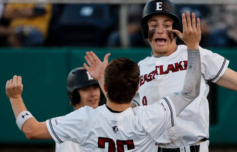 Eastlake’s Graddy Woodward celebrates with Levi Joyce after Woodward came around to score during the fifth inning.  223895