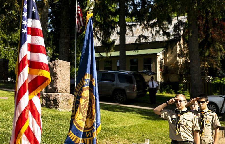Boy Scouts salute as the national anthem is performed during a Memorial Day ceremony, Monday, May 29, 2023, at Oakland Cemetery in Iowa City, Iowa. (Joseph Cress/Iowa City Press-Citizen via AP) IAIOP110 IAIOP110