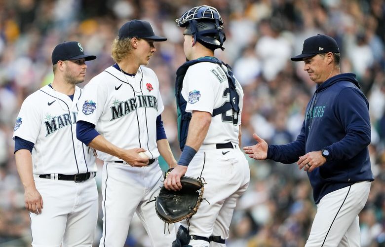 Seattle Mariners starting pitcher Bryce Miller, center, is taken out of the game against the New York Yankees by manager Scott Servais, right, as first baseman Ty France, left, and catcher Cal Raleigh (29) watch during the fifth inning of a baseball game Monday, May 29, 2023, in Seattle. (AP Photo/Lindsey Wasson) WALW132 WALW132