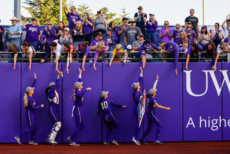 The Huskies celebrate their berth into the College World Series with their fans. (Dean Rutz / The Seattle Times)