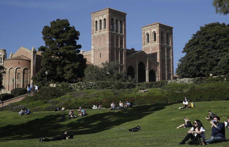 FILE – Students sit on the lawn near Royce Hall at UCLA in the Westwood section of Los Angeles on April 25, 2019. After statewide bans on affirmative action in states from California to Florida, colleges have tried a range of strategies to achieve a diverse student body – giving greater preference to low-income families and admitting top students from communities across their states. But after years of experimentation, some states requiring race-neutral policies have seen drops in Black and Hispanic enrollments. (AP Photo/Jae C. Hong, File) XKS201 XKS201