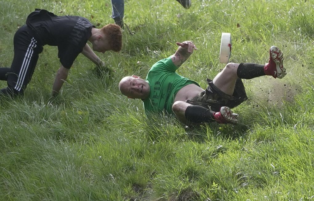 Rolling thunder: Contestants chase cheese wheel down a hill in chaotic UK  race