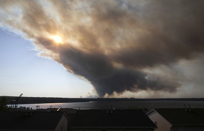 Thick plumes of heavy smoke fill the Halifax sky as an out-of-control fire in a suburban community quickly spread, engulfing multiple homes and forcing the evacuation of local residents, in Halifax, Nova Scotia, on Sunday May 28, 2023. (Kelly Clark/The Canadian Press via AP) HALX201 HALX201