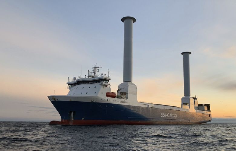 The SC Connector, a freight-hauling vessel owned by  Sea-Cargo, sails on the North Sea off  Norway in 2021. The ship is equipped with two rotor sails manufactured by Finland-based Norsepower. The 38-yard-high (35-meter-high) rotors spin in the wind and help propel the vessel. It’s an example of new technologies helping the shipping industry reduce its greenhouse gas emissions. (Artur Sylwestrzak / Sea-Cargo via AP). 