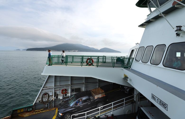 Passengers enjoy the view from the Washington state ferry, the M/V Chelan, on its way to Friday Harbor, San Juan Island on May 2, 2023.