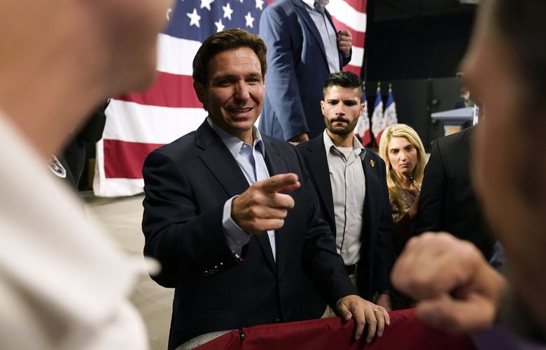 Republican presidential candidate Florida Gov. Ron DeSantis greets audience members during a campaign event, Tuesday, May 30, 2023, in Clive, Iowa. (AP Photo/Charlie Neibergall) IACN110 IACN110