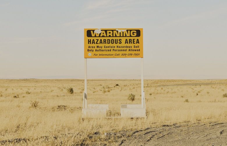 A radiation warning sign along the road near the Hanford Site in Washington state, on Aug. 10, 2022. Hanford, the largest and most contaminated of all American nuclear weapons production sites, is too polluted to ever be returned to public use. Cleanup efforts are now at an inflection point.  (Mason Trinca/The New York Times)