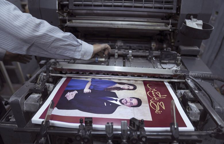A Jordanian specialist follows the process of printing posters with pictures of Crown Prince Hussein and his fiancee, Saudi architect Rajwa Alseif and reads “we celebrate Hussein,” at a print house in Amman, Jordan, Wednesday, May 31, 2023. Crown Prince Hussein and Saudi architect Rajwa Alseif are to be married on Thursday at a palace wedding in Jordan, a Western-allied monarchy that has been a bastion of stability for decades as Middle East turmoil has lapped at its borders.(AP Photo/Nasser Nasser) NN104 NN104
