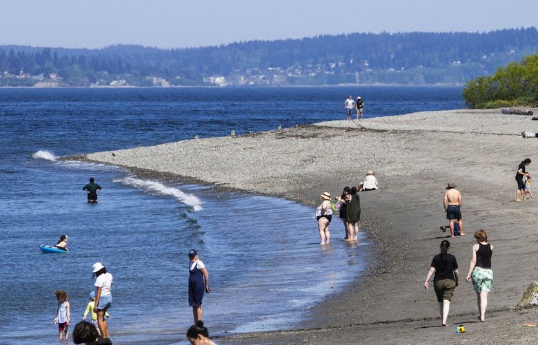 The scene at Golden Gardens could be described as beachy-keen as temperatures again edge into the 80s and the area braces for more heat this week, Monday, May 15, 2023 in Seattle.