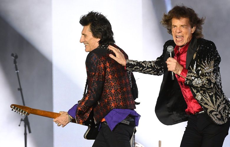 Old dads Ronnie Wood, left, and Mick Jagger of the Rolling Stones perform in July 2019 at FedEx Field in Landover, Md. MUST CREDIT: Washington Post photo by Matt McClain