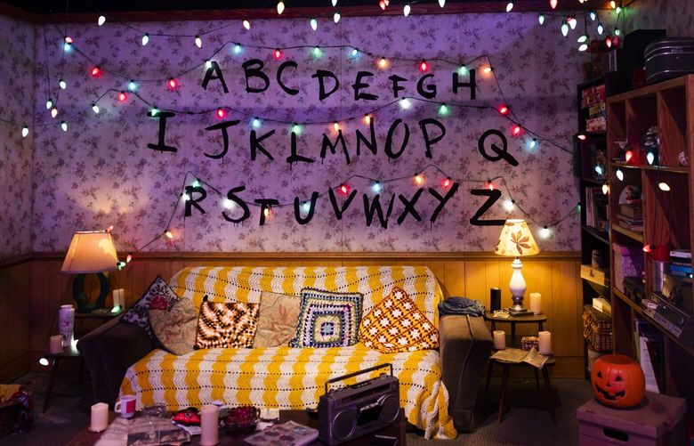 Lights hang in the Byers’ living room at the “Stranger Things: The Experience” in Seattle on Thursday, May 25, 2023.
