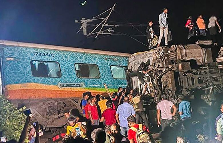 MANDATORY CREDIT- Rescuers work at the site of passenger trains that derailed in Balasore district, in the eastern Indian state of Orissa, Friday, June 2, 2023. Two passenger trains derailed in India, killing at least 13 people and trapping hundreds of others inside more than a dozen damaged coaches, officials said. About 400 people were injured and taken to hospitals, and the cause of the accident was under investigation, officials said. (Press Trust of India via AP) DEL101 DEL101