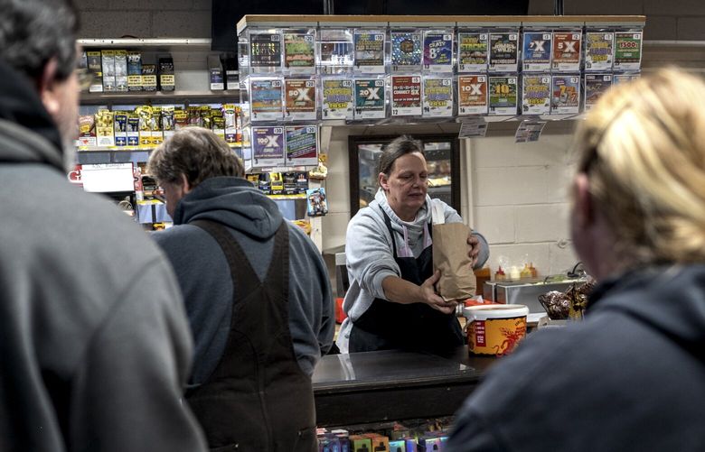 Patrons gather to purchase a hot breakfast inside the Ebony General store owned by Mohammed Abouemara, which is much-loved by local residents, in Ebony, Va. on Feb. 3, 2023. Many locals with ties to Ebony think a planned Dollar General store will open the door to additional development that will spoil the character of their tiny, rural community of about 230 people. The name of their website and the rallying cry for their campaign against the Dollar General is “Keep Ebony Country.” (Andrea Bruce/The New York Times)