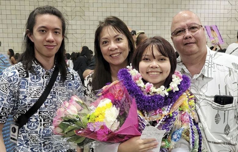 In this photo provided by Vernon Tyau, Jarek Agcaoili, left, with his mother Danielle, sister Jessika and father Maury Agcaoili pose in May 2023, at Jessika’s high school graduation in Hawaii. Danielle and Maury Agcaoili were among boaters who died Sunday, May 28, 2023, near Sitka, Alaska, when a fishing vessel ran into trouble in rough seas. (Vernon Tyau via AP) NY801 NY801
