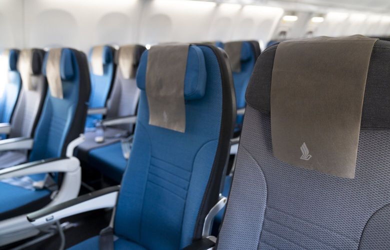 Seats in the economy class cabin of a Boeing Co. 737 Max 8 aircraft, operated by Singapore Airlines Ltd., during a media event hosted by the airline at the JetQuay CIP Terminal of Changi Airport in Singapore, on Tuesday, Nov. 16, 2021. Singapore Airlines unveiled its first new cabin offering in more than three years after spending S$230 million ($170 million) on the design and installation of seats on its 154-seat Boeing Co. 737 Max planes. Photographer: Ore Huiying/Bloomberg
