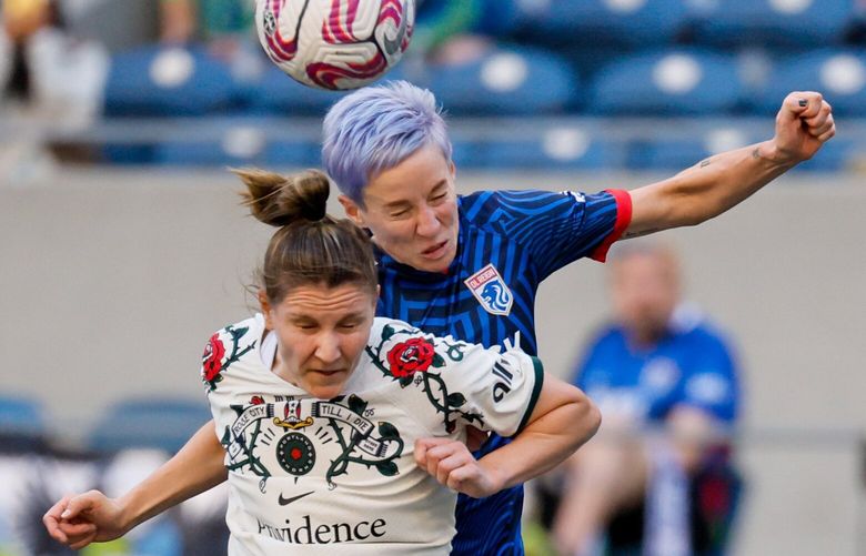 Portland Thorns FC defender Natalia Kuikka and OL Reign forward Megan Rapinoe go up for a header during the first half. 224068