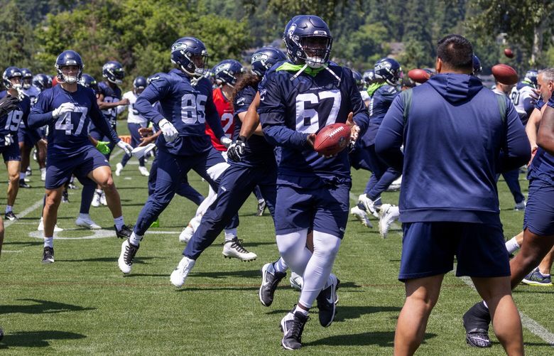 Seahawks offensive players run a drill during an OTA, Thursday, June 1, 2023 in Renton.