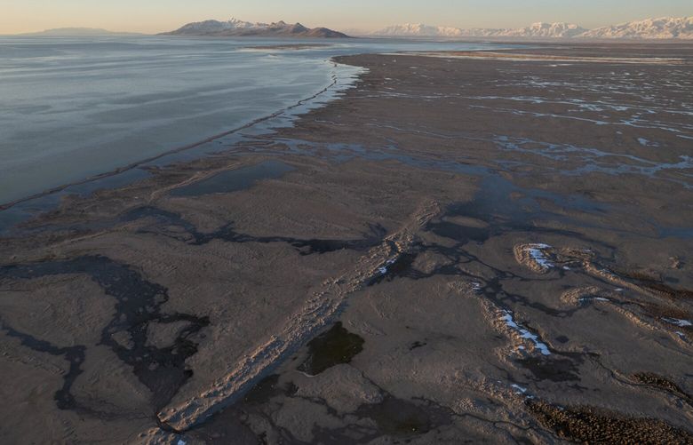 Snow and water pool up on a stretch of exposed lakebed on the southern end of the Great Salt Lake in Magna, Utah, in April. MUST CREDIT: Photo for The Washington Post by James Roh.